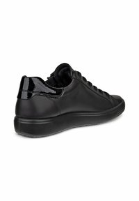 Black leather sneaker with a smooth texture, flat sole, and shiny patent accents on the heel. Laced design and low-top silhouette.