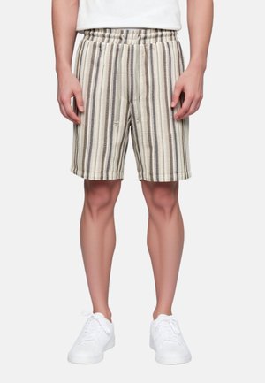 Stripete shorts med elastisk midje i beige, brun og krem. Materialet har en teksturert veving. Har sidelommer og knelengde.