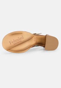 Brown leather shoe sole with embossed branding "Felmini HANDMADE" and size "37". Smooth texture with a slight curve and rounded heel.