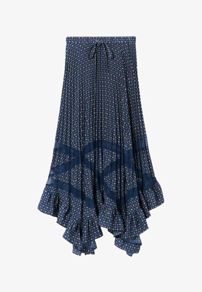 Jupe plissée bleu marine avec un ourlet à volants, présentant un motif floral géométrique en vert clair et crème. Détail de taille à nouer.