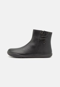 Black leather ankle boots featuring a rounded toe, minimal stitching, and decorative laces on the side; smooth texture and flat sole.