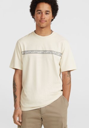 Korte mouw beige t-shirt van katoen, met een zwart patroon over de borst, ronde halslijn en een relaxte pasvorm.