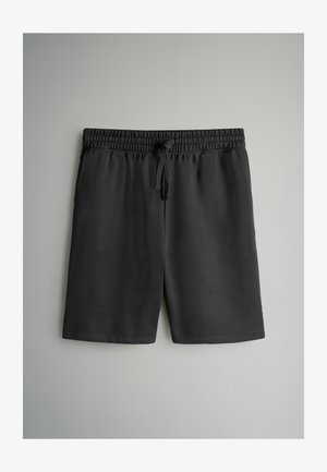 Black athletic shorts with an elastic waistband and adjustable drawstring. Smooth texture, knee-length design, and no visible pockets.