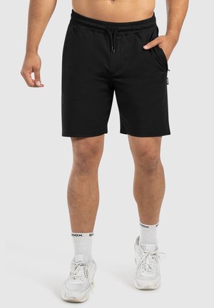 Schwarze Shorts mit elastischem Bund, Kordelzug und Seitentasche. Hergestellt aus glattem Stoff, knielang im minimalistischen Design.