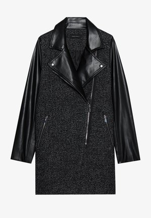 Black and gray herringbone coat with leather sleeves and oversized lapels. Features zippered pockets and asymmetrical front zipper closure.