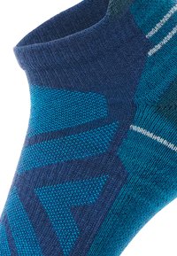 Ankle sock featuring a gradient design in dark blue and turquoise, with textured patterns and a ribbed cuff.