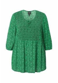 Tunika verde con stampa floreale, maniche a tre quarti, scollatura rotonda e dettaglio con nodo sul davanti. Tessuto leggero e texturizzato.