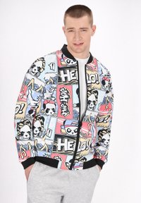 Multicolored bomber jacket featuring graphic panels with cartoon pandas, text, and abstract designs. Made from smooth fabric with ribbed cuffs.