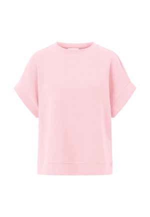 T-shirt rosa a maniche corte realizzato in cotone morbido. Presenta un collo rotondo e una vestibilità larga e boxy con risvolti e un design semplice.