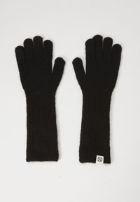 Guanti neri lavorati a maglia con texture a coste, di lunghezza lunga e un piccolo etichetta con logo sul polso. Il materiale morbido offre calore e comfort.