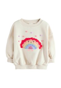 Cremfarbener Sweatshirt mit Puffärmeln, das ein farbenfrohes, gesticktes Regenbogenmuster und strukturierte Pompoms auf der Vorderseite aufweist.