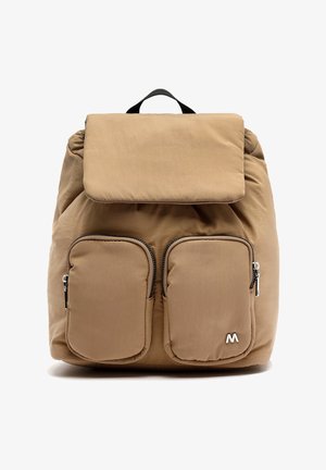 Tkaninový batoh béžovej farby s polstrovaným klopom, dvoma prednými vreckami na zips a vertikálnym čiernym popruhom hore; obsahuje minimalistické logo.