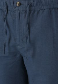 Mörkblå dragsko byxor i lättviktig tyg med knappstängning, med en texturerad yta och sidofickor.