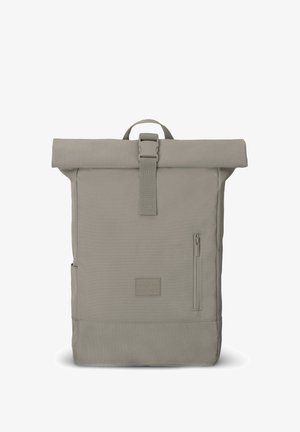 Gray roll-top backpack made of durable fabric, featuring a front zipper pocket, adjustable straps, and a logo patch at the bottom.