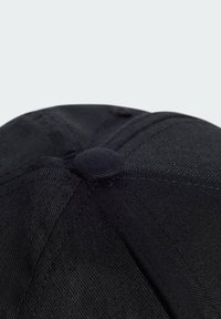 Black cap with a rounded top, made of textured fabric. Features a centered button and stitched seams, highlighting its structured design.