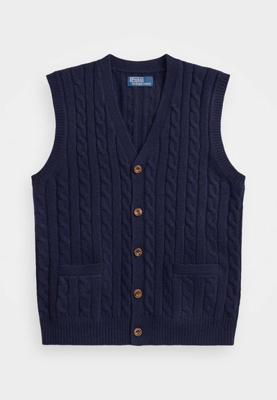 Marineblå strikket vest med kabelmønster, V-hals og fem brune knapper. Har to frontlommer og brede armhull. Strukturert stoff.