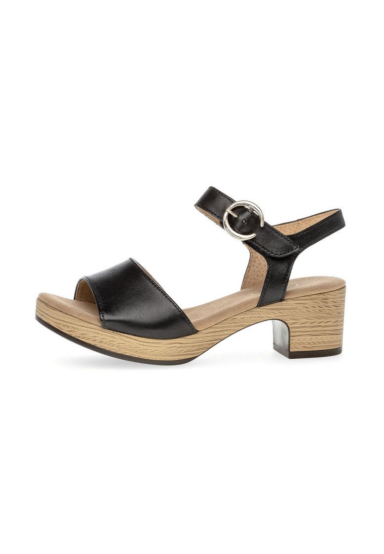 Black leather sandal with an adjustable ankle strap and silver buckle, featuring a wood-textured block heel and open toe design.