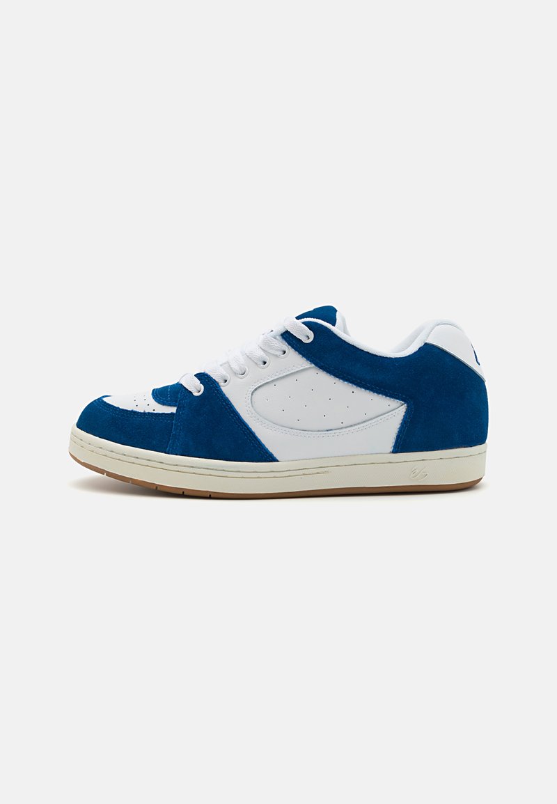 Blue suede and white leather sneaker with a rounded toe, perforated detailing, and a rubber sole. Lace-up design with a padded collar.