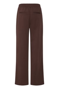 Brune vide bukser med bred benvidde, elastisk midjebånd og to baklommer med åpning, vist bakfra.