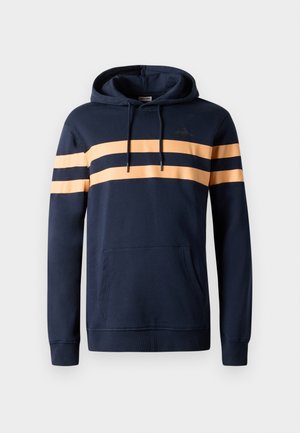 Laivastonsininen huppari, joka on valmistettu puuvillasekoitteesta. Siinä on kaksi vaakasuoraa oranssia raitaa, etutasku ja säädettävät nyörit hupussa.