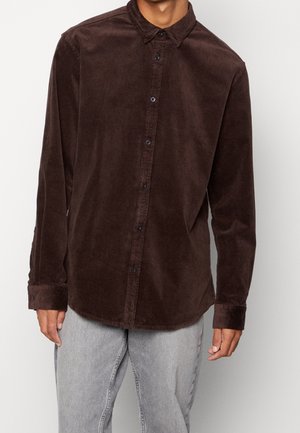 Bruine corduroy blouse met een button-down kraag, knopen aan de voorkant en lange mouwen, met een getextureerde stof en een ontspannen pasvorm.