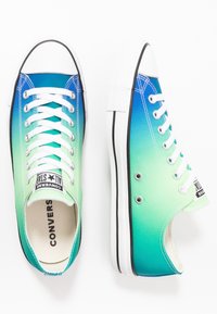 Green to blue gradient high-top canvas sneakers with white laces, black rubber toe cap, and classic black stripe on the sole.