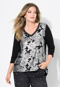 Top floreale nero e argento con maniche a tre quarti, scollatura a V, motivo floreale sul davanti e maniche e retro neri uniti.