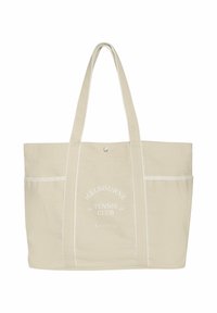 Beżowa torba na ramię z płótna, z dwoma uchwytami, białymi akcentami, nadrukowanym napisem "Melbourne Tennis Club" oraz pojedynczym zapięciem na zatrzask.