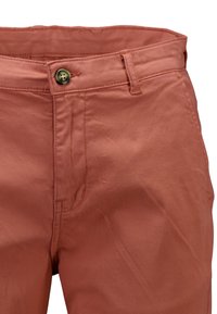 Pantalon couleur rouille avec un bouton et des passants de ceinture, coutures visibles autour de la taille et des poches.