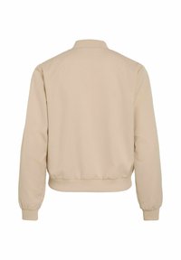 Veste bomber beige à manches longues avec col, poignets et ourlet côtelés, vue de dos sur fond blanc uni.
