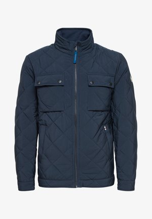 Granatowa pikowana kurtka z kołnierzem stójkowym, dwoma kieszeniami na piersi z zapięciem na zatrzask, zamkiem z przodu oraz kontrastowym wykończeniem po lewej stronie.