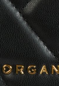 Materiale in pelle nera con finitura strutturata e un logo dorato in rilievo. Il design presenta cuciture diagonali e una forma elegante.