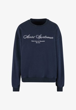 Tumedat sinine dressipluus ribitud varrukate ja äärega. Ees on valge sõnum ja logo, mis on valmistatud pehmest ja tekstureeritud kangast.