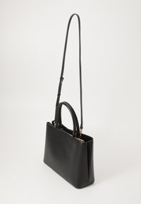 Black leather handbag with a structured design, featuring a top handle and an adjustable shoulder strap. Gold hardware accents included.