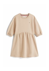 Robe beige à manches courtes en tissu texturé, avec une partie supérieure ajustée et une jupe froncée. Petit logo sur la poitrine.