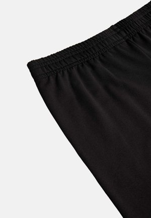 Pantalones cortos deportivos negros con cintura elástica y tejido suave y ligero con un sutil brillo.