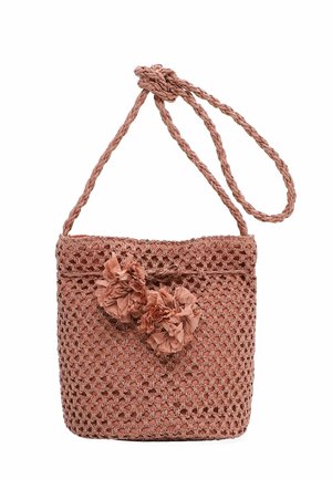 Woven pink shoulder bag with braided strap, featuring two decorative fabric pom-poms on the front closure.