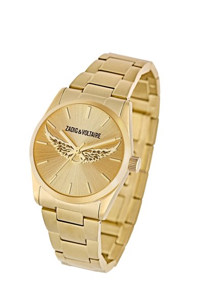Zlatý metalový náramkový hodinový stroj s prepojeným náramkom, slnečným ciferníkom, dizajnom krídel na ciferníku a logom Zadig & Voltaire.