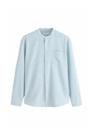 Gaiši zils, garām piedurknēm krekls ar lentes apkakli, priekšā pogas aizdare un krūšu kabata. Izgatavots no teksturēta, elpojoša auduma.