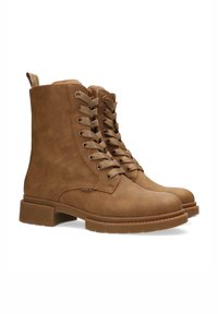 Botines de cuero marrón con punteras redondas, cordones en la parte delantera y lengüeta en la parte posterior. Suela de goma texturizada con relieves. Diseño sencillo, sin adornos adicionales.