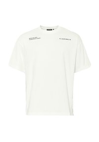 White cotton t-shirt with a loose fit, featuring black printed text "BREAKING CONVENTIONS" and "ELIASRUMELIS" on the front.