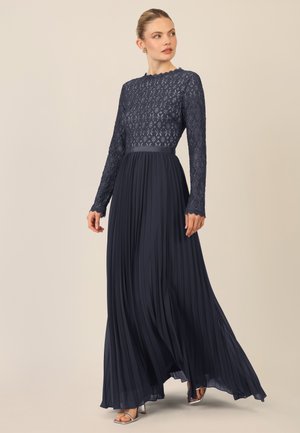Marineblaue gefaltete Kleid mit einem Spitzenoberteil und langen Ärmeln, versehen mit einem runden Ausschnitt und einem Banddetail in der Taille.