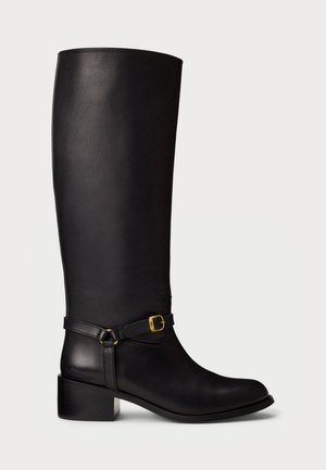 Black leather knee-high boot with low block heel and decorative strap featuring a small gold buckle on the ankle.