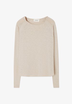 Beige långärmad topp i ett mjukt, strukturerat tyg. Har rund halsringning och raglanärmar. Rundad nederkant med en avslappnad passform.
