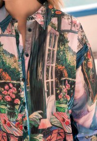 Veelkleurig, lichtgewicht overhemd met knopen, met een tuinscène, bloemenpatronen en een deurontwerp. Soepele, doorschijnende textuur met een kraag.