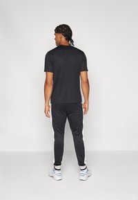 Fila PANTS BAME - Spodnji deli trenirk - black/white alyssum