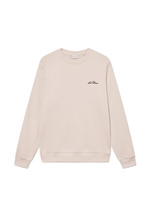 Sudadera beige clara hecha de una suave mezcla de algodón, con mangas largas, cuello redondo y un pequeño logo negro en el pecho.