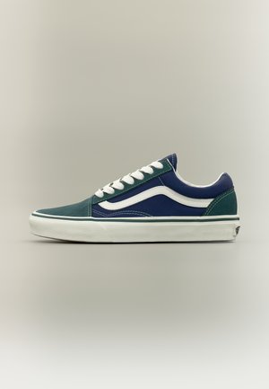 Low-top sneaker with blue and green panels, white side stripe, white laces, and thick white sole on neutral background.