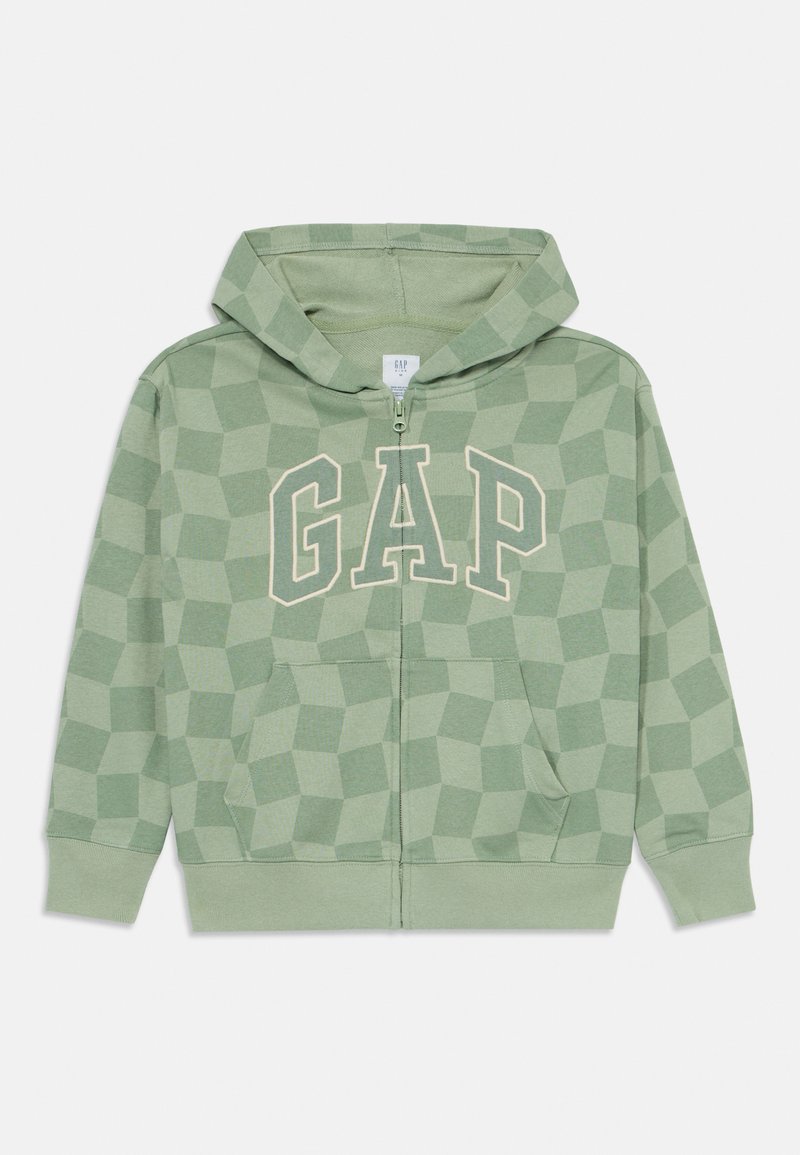 Haut de survêtement zippé vert clair en tissu doux, orné d'un motif géométrique et du logo 'GAP' en beige clair. Comprend des poches avant et une capuche.