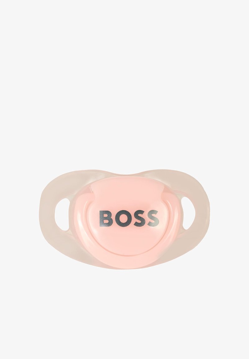 Chupeta rosa com acabamento brilhante, apresentando uma forma circular e a palavra "BOSS" em prata, contornada por manípulos laterais de plástico transparente.
